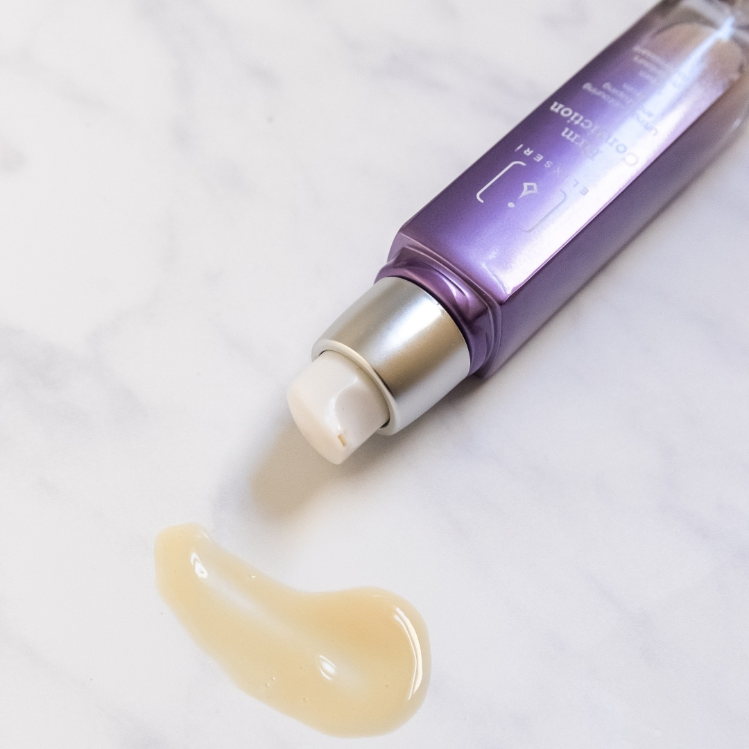 Elixseri's Firm Conviction firming, lifting and contouring serum laying on it's side with gel like serum visible.