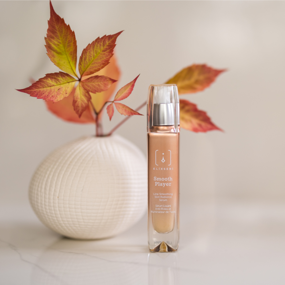 Elixseri Smooth Player line smoothing anti ageing serum in front of a white vase with red autumn leaves in