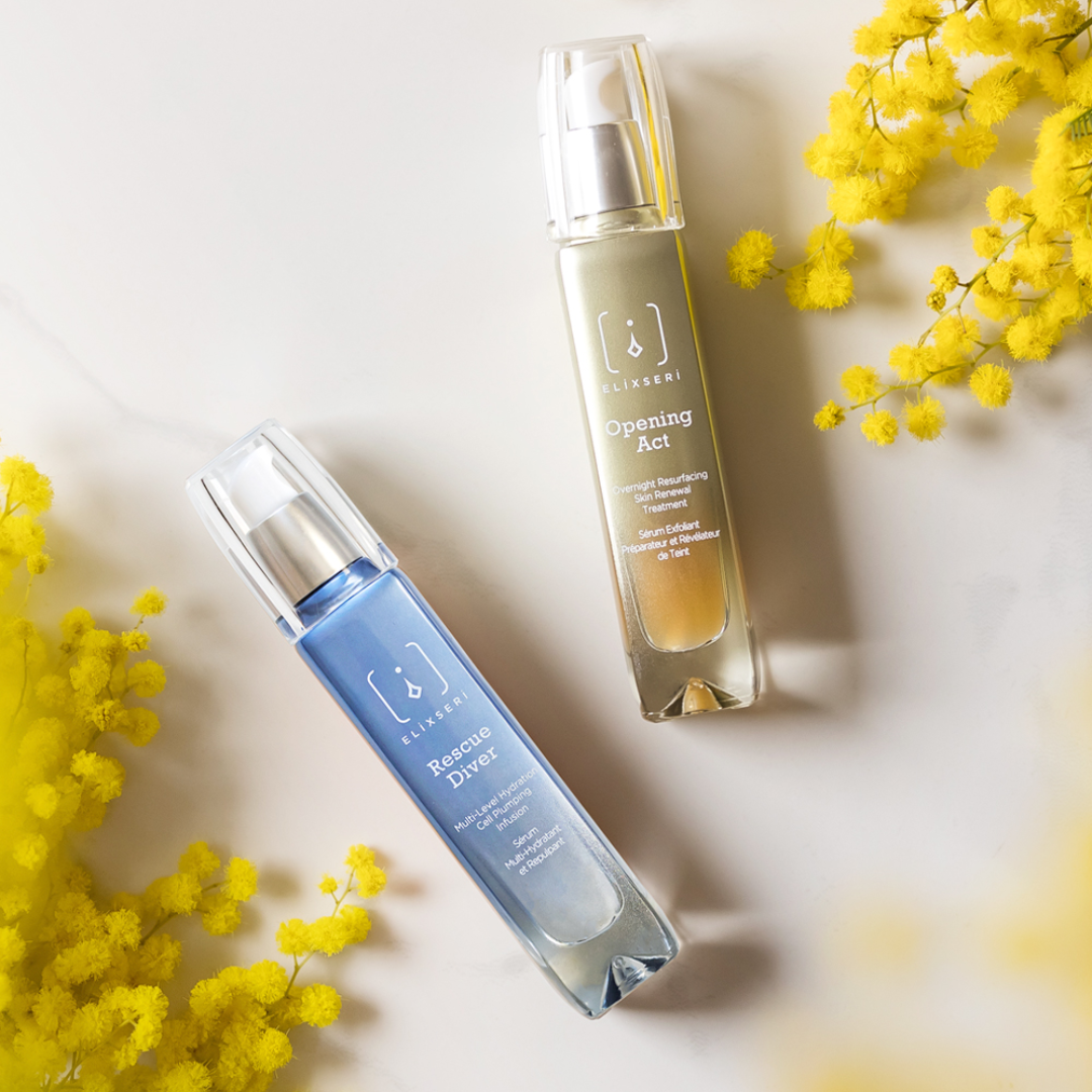 Elixseri Opening Act and Rescue diver serum bottles on a pale background with yellow Mimosa flowers