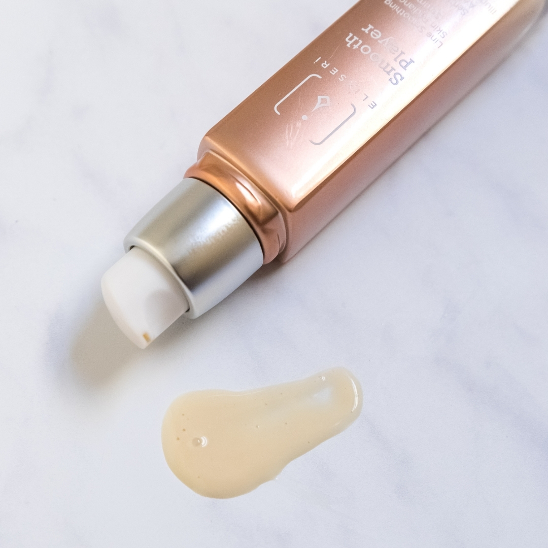 Elixseri's Smooth Player line smoothing, skin radiance serum laying on it's side with creamy serum visible.