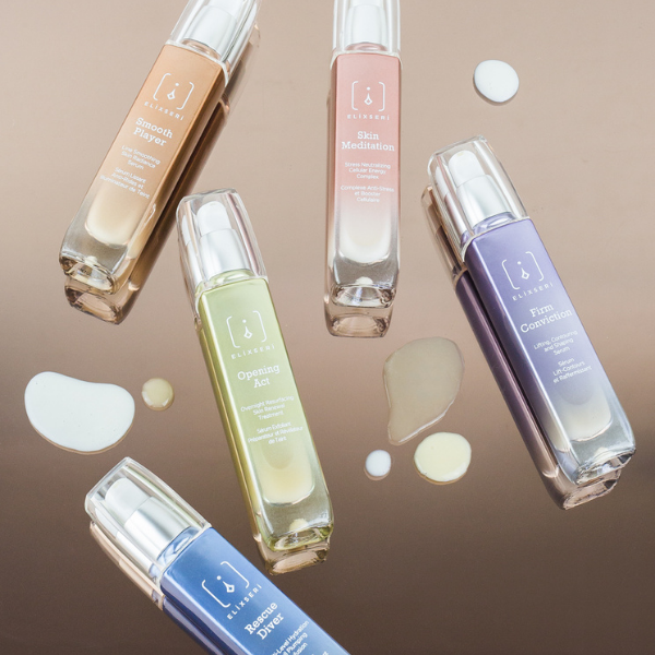 Elixseri serums laid down on a shiny surface with their creamy serum textures