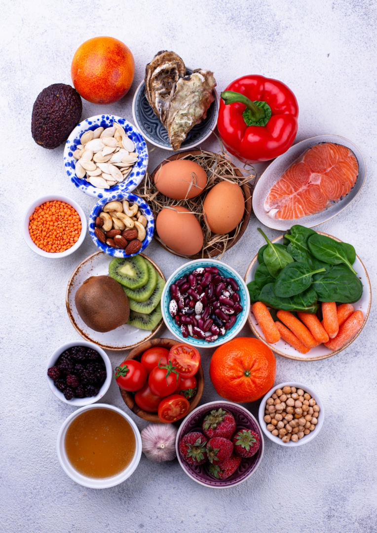 Fish, eggs, fruit and vegetables displayed as part of a healthy collagen rich diet.