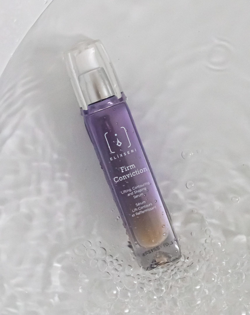 Elixseri Firm Conviction, lifting, contouring and shaping serum lying in water. 