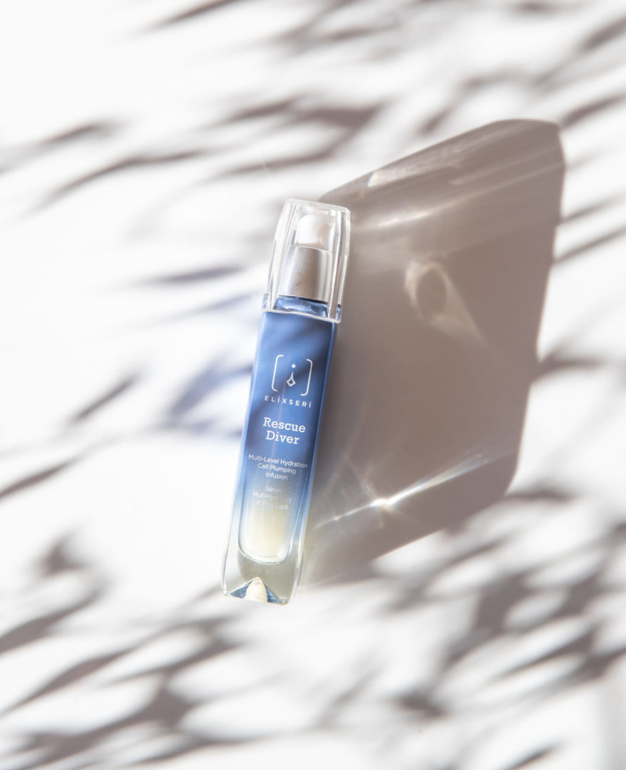 Elixseri Rescue Diver, multi-level hydration. cell plumping serum lying in dappled sunshine. 