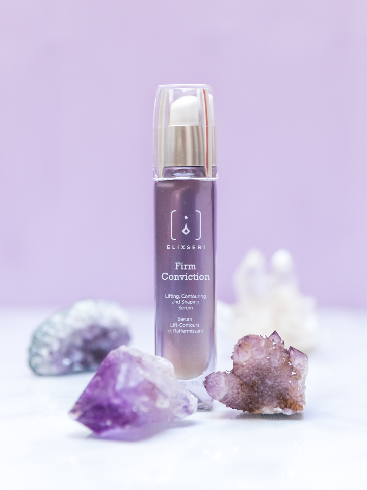 Elixseri Firm Conviction anti-ageing serum standing amongst Amethyst crystals. Lifting, contouring and shaping serum. 