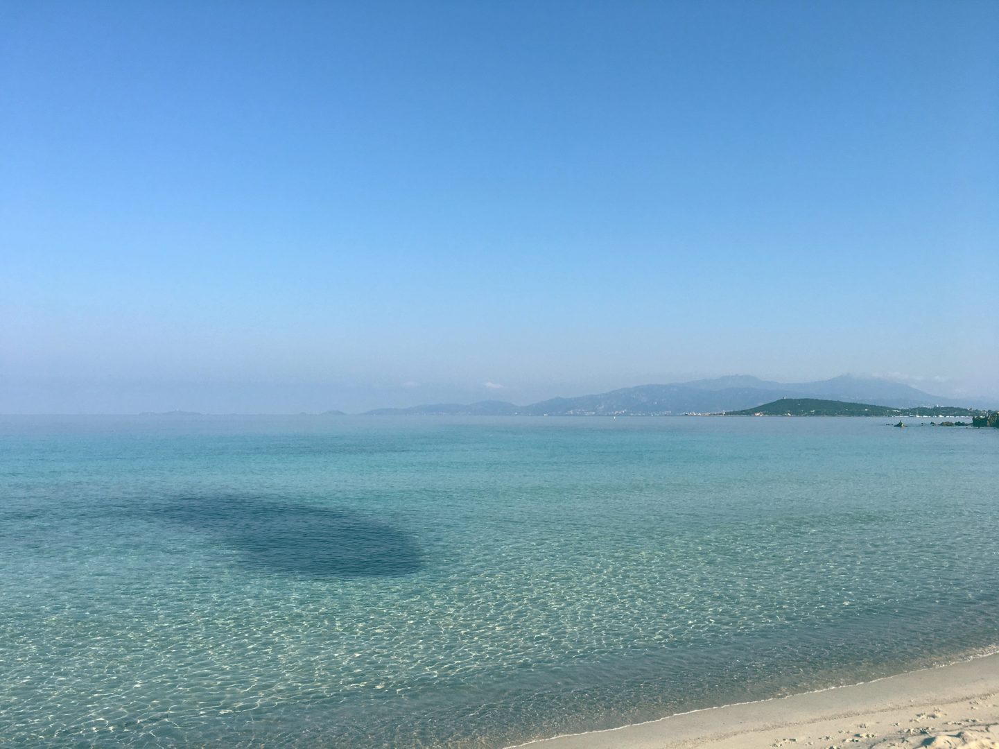 Mare e Sole beach in Corsica with beautiful blue waters and white sand.