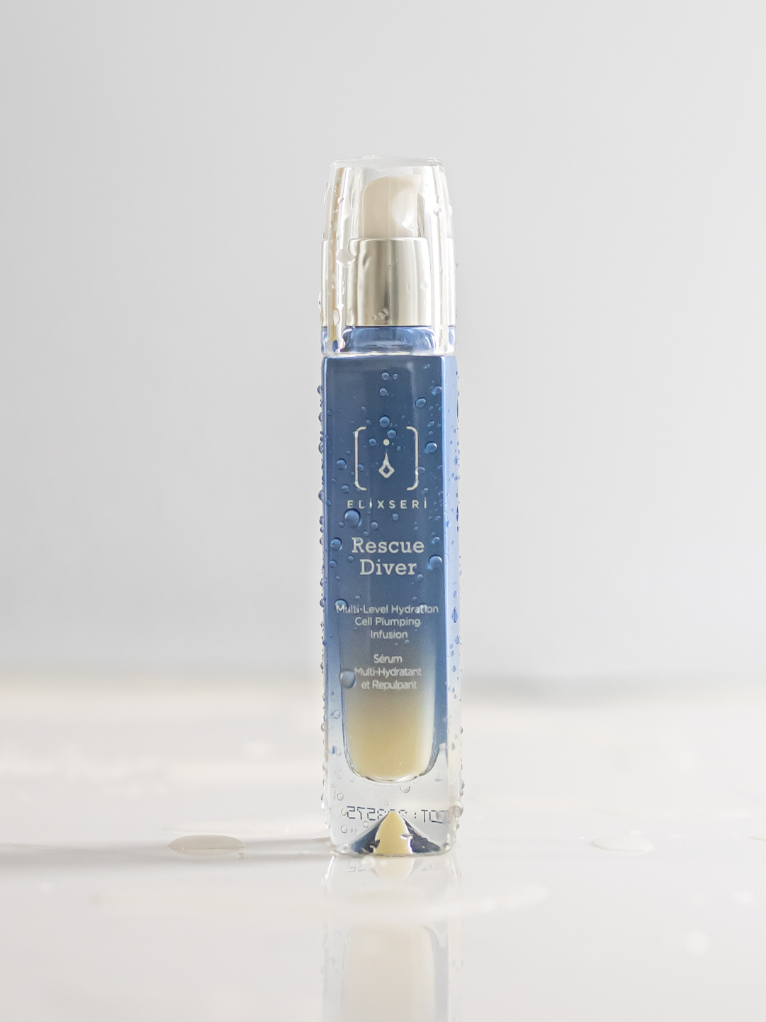 Elixseri's Rescue Diver multi level hydation serum pictured with drops of water on the bottle