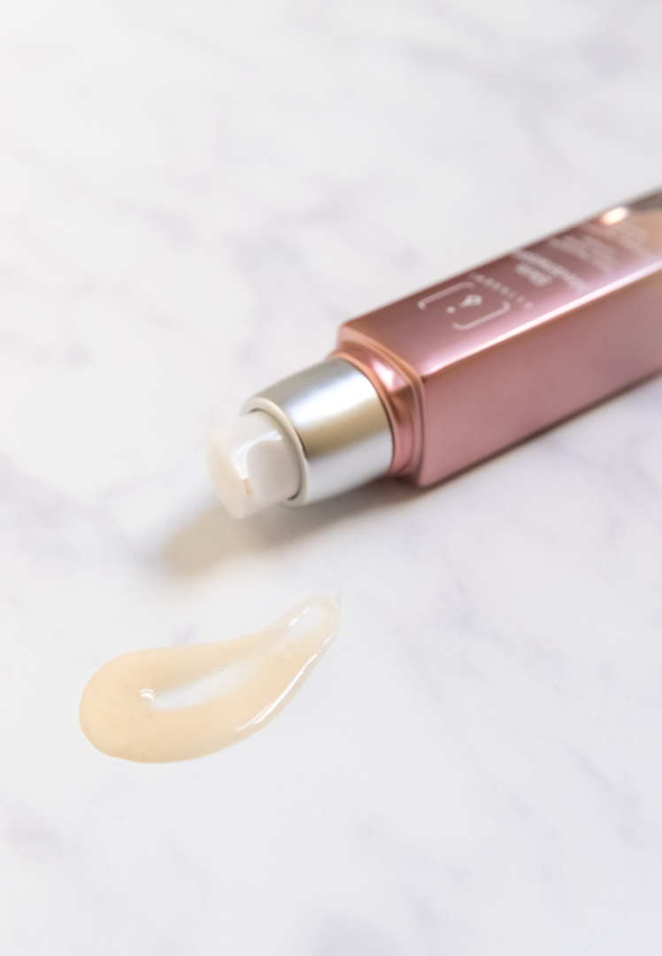 Elixseri's Skin Meditation skin serum pictured lying down with a drop of product nearby
