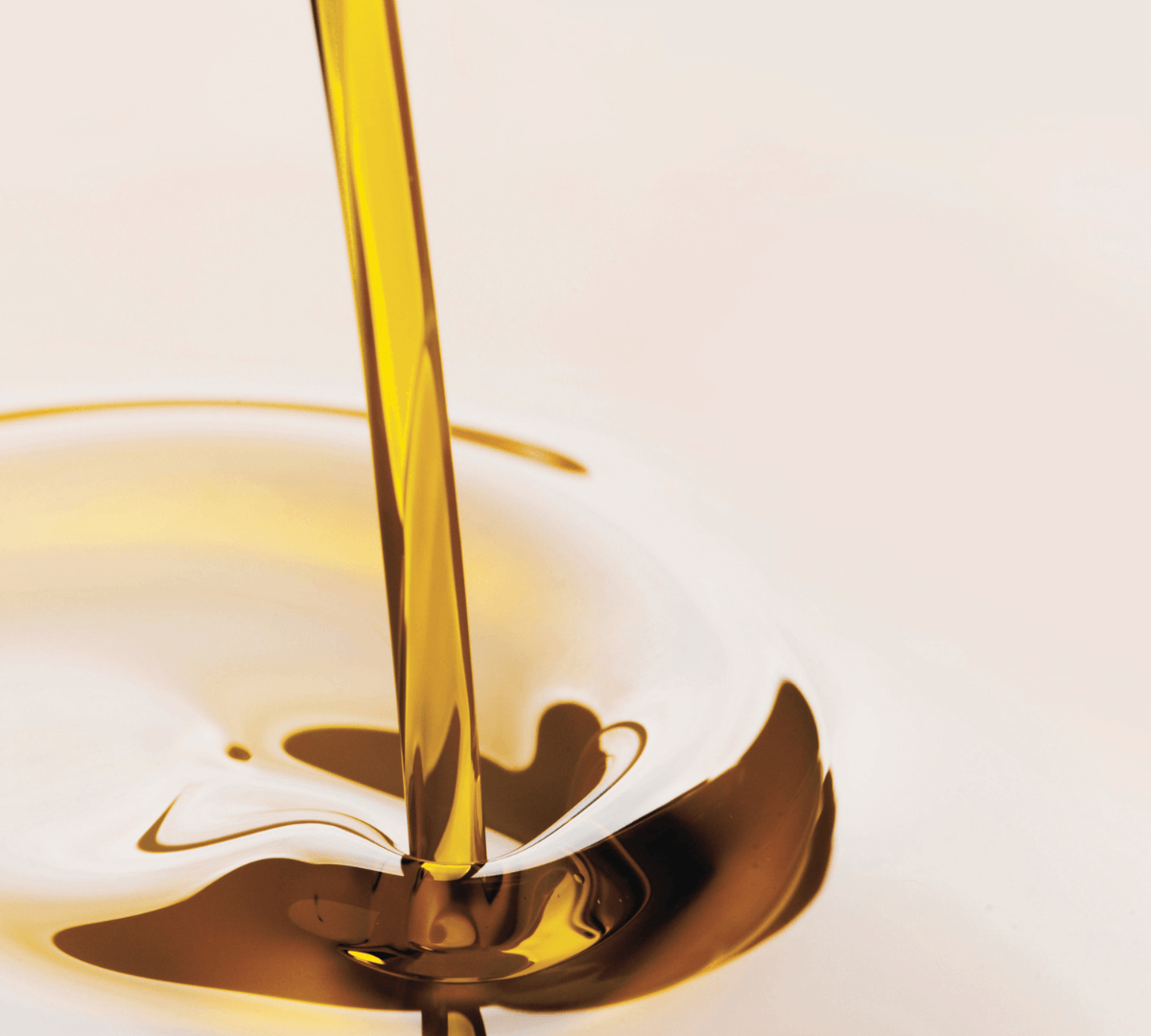 Golden lipid rich oil being poured