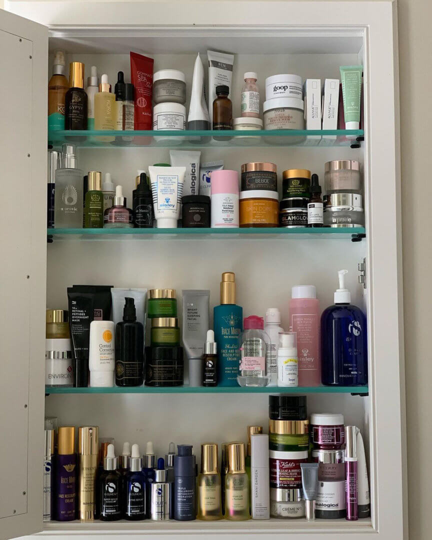 Lots of skincare products in a bathroom cabinet.