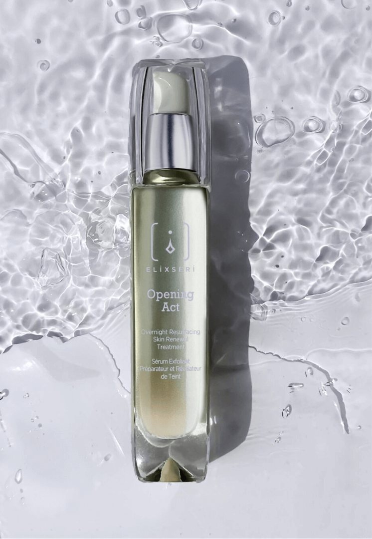 A green bottle of Elixseri Opening Act serum in a background of Swiss Alpine Light Water which is at the heart of each Elixseri serum.