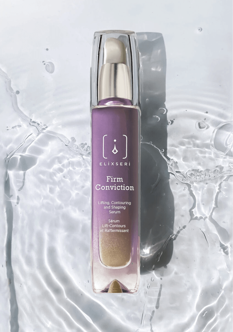 A purple bottle of Elixseri Firm Conviction serum in a background of Swiss Alpine Light Water which is at the heart of each Elixseri serum.