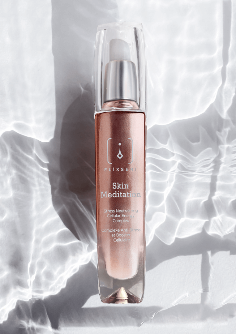 A copper coloured bottle of Elixseri Skin Meditation serum in a background of Swiss Alpine Light Water which is at the heart of each Elixseri serum.