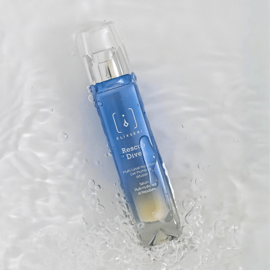 A blue bottle of Elixseri Rescue Diver serum in a pool of water